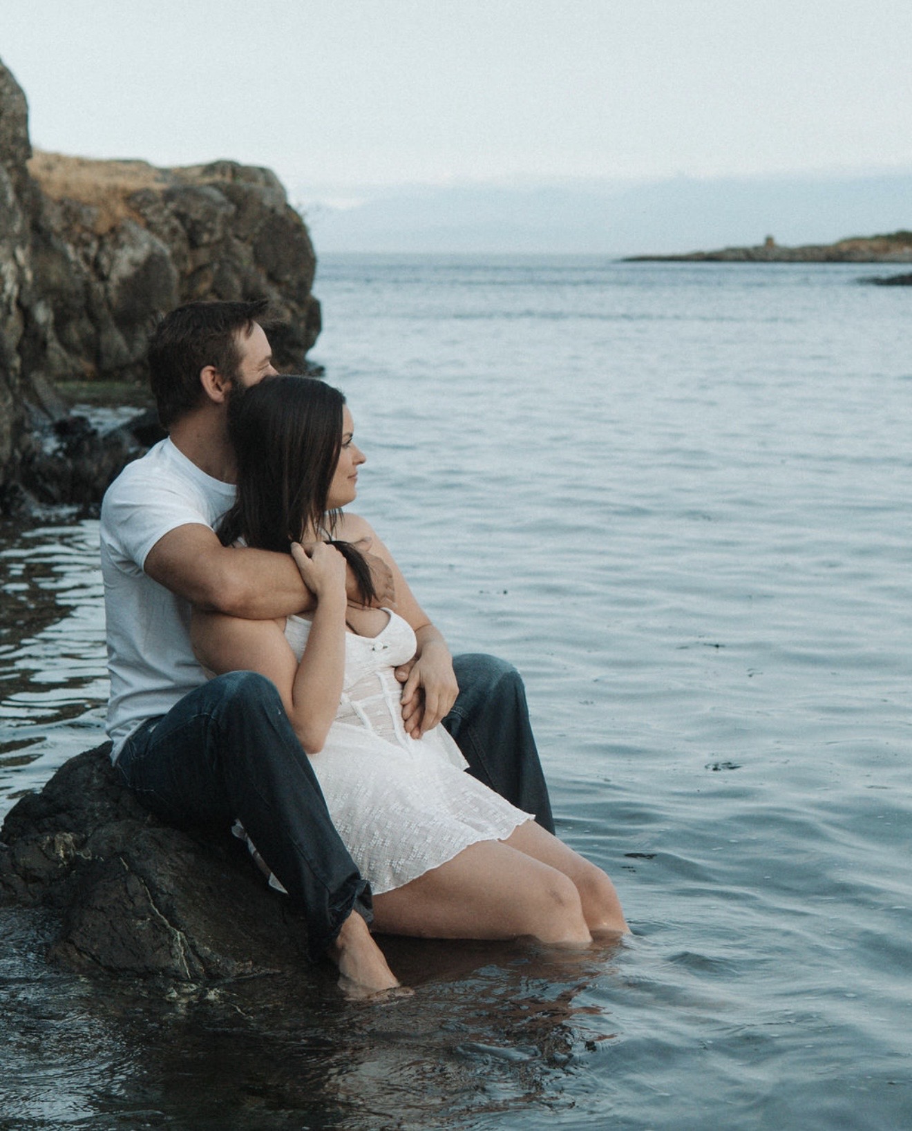 The founders of Hunting and Hooking BC sitting together beside the ocean