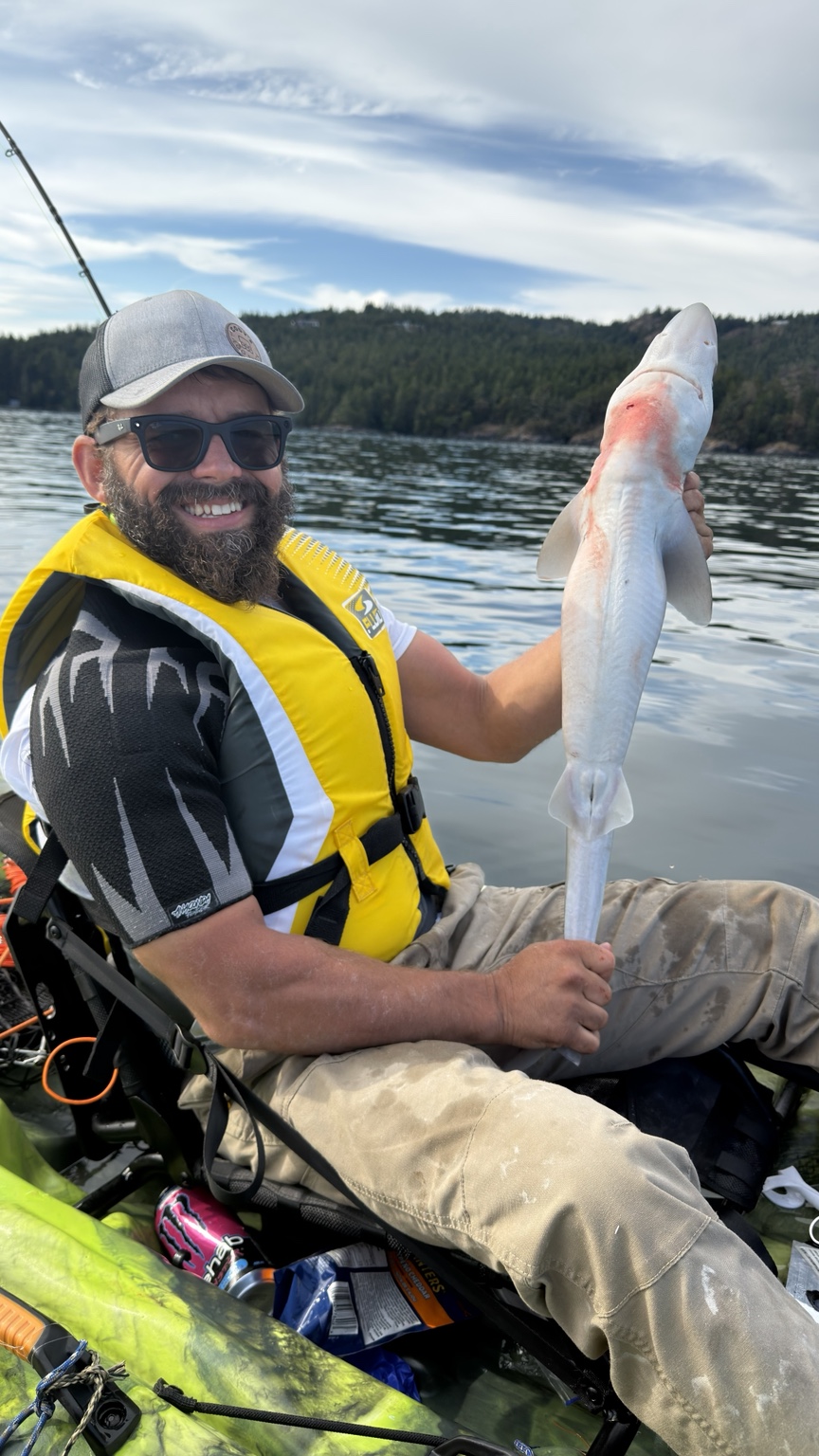 A kayak fishing adventure with a catch held up for the camera